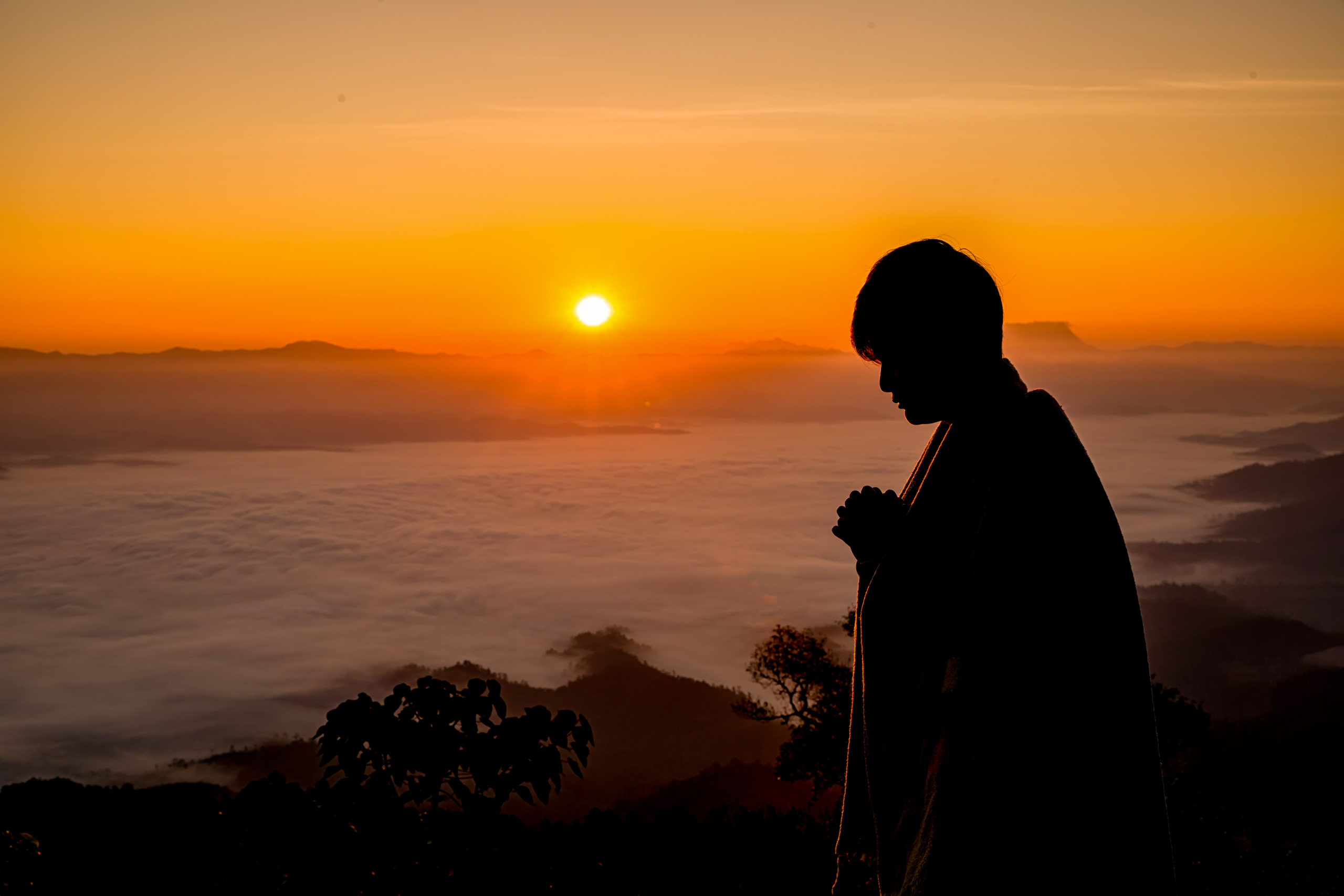 Silhouette of christian man hand praying,spirituality and religi